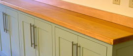 Our custom wood countertops and cabinets are a perfect complement to soapstone.